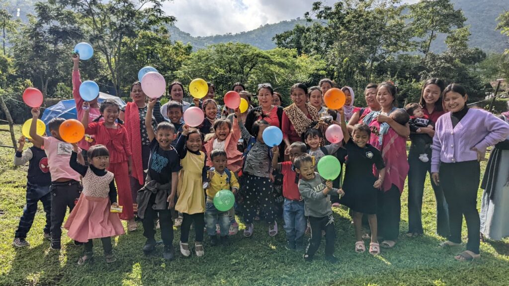 Children with balloons and staff of Tandan School